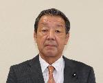 白い背景に、黒のスーツと、黒のネクタイを着用した副議長の白井幸吉さんの顔写真